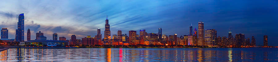 City skyline at dusk with lit buildings
